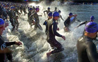 
At the sound of the starting cannon, more than 1,900 Ironman competitors hit the waters of Lake Coeur D'Alene on Sunday.
 (Christopher Anderson/ / The Spokesman-Review)