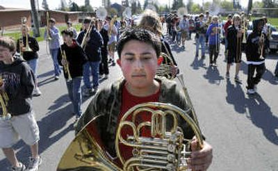 
Sacajawea Middle School student Kyle Conklin marches with his French horn and other band members Thursday on 33rd Avenue. The band was practicing its routine with  visits to The Waterford and Harvard Park senior homes and was on its way to perform for Sacajawea students. The band will participate in the Junior Lilac Parade on Saturday. 
 (Dan Pelle / The Spokesman-Review)