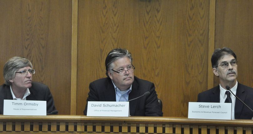 OLYMPIA Rep. Timm Ormsby, Office of Financial Management Director David Schumacher and State Economist Steve Lerch (left to right) look at figures explaining a small projected growth in state revenue over the next four years. (Jim Camden/The Spokesman-Review)