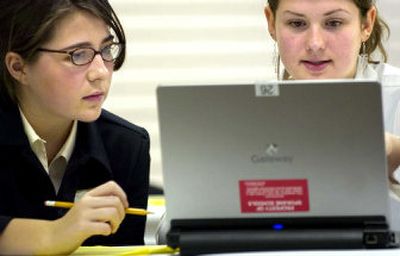 
Ferris High School seniors Michelle Sybouts, left, and Kendra Dane prepare a slideshow presentation during a competition at the Eastern Washington DECA state qualifying event on Wednesday morning. 
 (Holly Pickett / The Spokesman-Review)