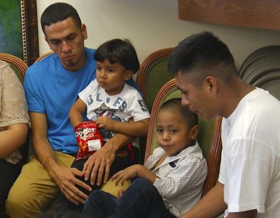 In this image taken from video, Javier Garrido Martinez, left and Alan Garcia, right, sit with their 4-year-sons at a news conference in New York, Wednesday, July 11, 2018. (Robert Bumsted / Associated Press)