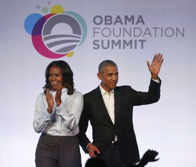In this Oct. 13, 2017 file photo, former President Barack Obama and former first lady Michelle Obama arrive for the first session of the Obama Foundation Summit in Chicago. Barack Obama and Netflix reportedly are negotiating a deal for the former president and his wife, Michelle, to produce shows exclusively for the streaming service. The proposed deal was reported Friday, March 9, 2018, by The New York Times, which cited people familiar with the discussions who were not identified. (Charles Rex Arbogast / Associated Press)