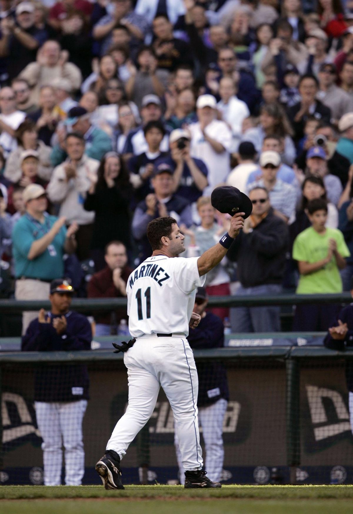 Former Seattle Mariners designated hitter Edgar Martinez waves to the crowd  at T-Mobile Park after he threw out the first pitch of a baseball game  between the Mariners and the Texas Rangers