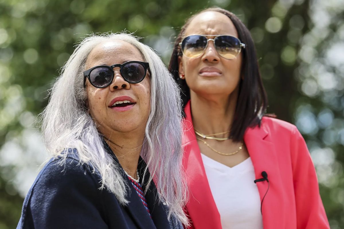 Cousins Maisha Barnett, left, and Ghanya Thomas address the gathering for the newly dedicated Conna Park in Federal Way, Wash., on Wednesday. The name honors their ancestor, John Conna, who fought for the Union Army in the Civil War and lobbied for civil rights. The park sits on property Conna and his wife Mary homesteaded. (Kevin Clark/Seattle Times)