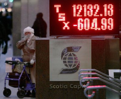 A pedestrian stands beside a TSX market sign indicating the final close, down nearly 605 points, in Toronto on Monday Jan. 21, 2008. Stocks fell sharply worldwide Monday following declines on Wall Street last week amid investor pessimism over the U.S. government's stimulus plan to prevent a recession. (AP Photo/The Canadian Press, J.P. Moczulski) ORG XMIT: CPTM101 (J.P. Moczulski / AP)