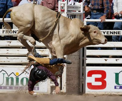ORG XMIT: WYLAR104 Justin Hatheway of Hot Springs, S.D. is thrown from a bull while competing at the Cheyenne Frontier Days outdoor rodeo and western celebration Monday July 20, 2009 in Cheyenne, Wyo.  (AP Photo/Laramie Boomerang, Andy Carpenean) (Andy Carpenean / The Spokesman-Review)