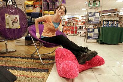 
A college student poses in a spandex chair and rests her feet on a fuzzy backrest in the campus shop at the JC Penney store in Lewisville, Texas. College students prepare diligently for dorm room decorating. The trend has been a boon to home furnishings stores and big chains, which are expanding their dorm room decor. 
 (AP / The Spokesman-Review)