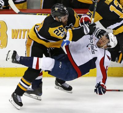 Pittsburgh Penguins’ Ian Cole (28) checks Washington Capitals’ Justin Williams (14) off the puck during the third period of Game 4 in an NHL Stanley Cup Eastern Conference semifinal hockey game in Pittsburgh, Wednesday, May 3, 2017. The Penguins won 3-2. (Gene J. Puskar / Associated Press)