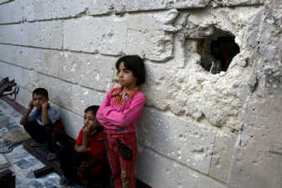 
Children stand outside their damaged house Saturday in  Sadr City, where U.S. soldiers launched a pre-dawn raid. Iraqi  officials said the victims were civilians. Associated Press
 (Associated Press / The Spokesman-Review)