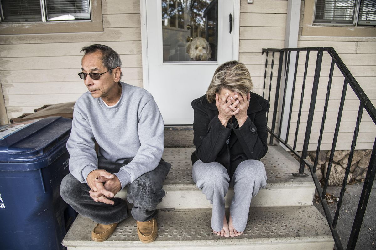 Lori Rayburn breaks into tears Saturday, Oct. 22, 2016, when learning the details of a 3-year-old boy’s death in a fire while huddled with his dog. Her husband, Jerry Atabelo, left, tried to fight the fire on Friday night with a garden hose from their home at the corner of Myrtle Street and Longfellow Avenue in Spokane. (Dan Pelle / The Spokesman-Review)