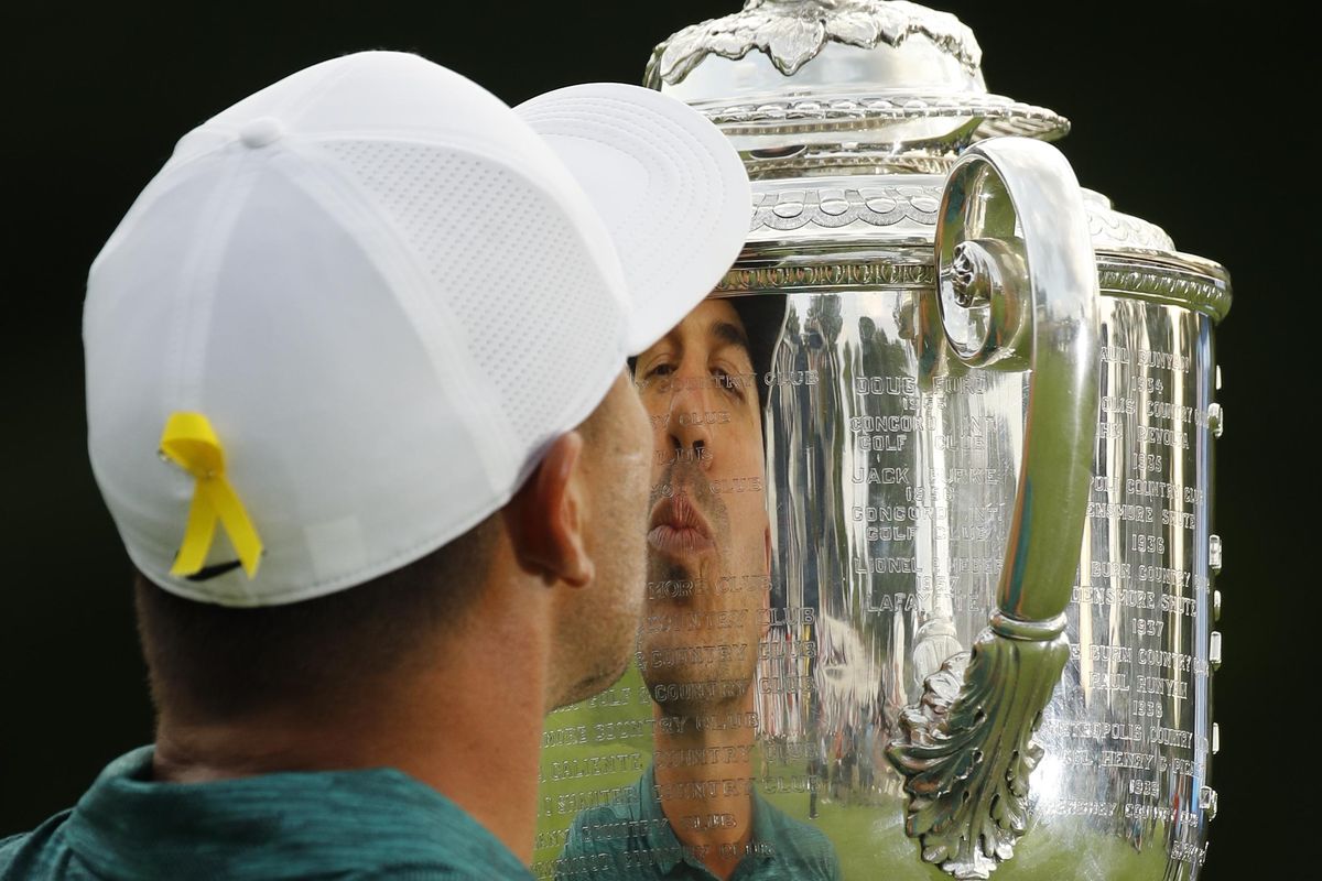 Brooks Koepka kisses the Wanamaker Trophy after winning the PGA Championship golf tournament at Bellerive Country Club, Sunday, Aug. 12, 2018, in St. Louis. (Charlie Riedel / Associated Press)
