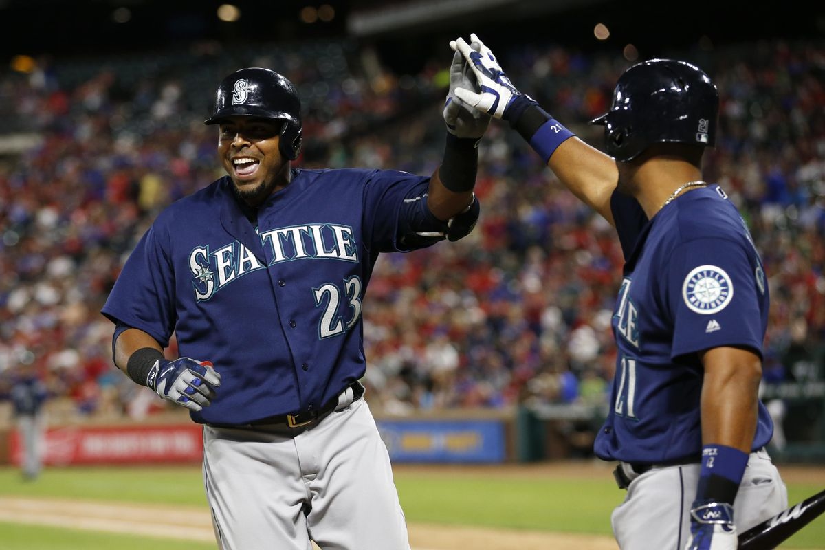 Seattle Mariners’ Nelson Cruz is congratulated by Franklin Gutierrez, right, on his solo home run against the Texas Rangers in the fourth inning of a baseball game, Tuesday, April 5, 2016, in Arlington, Texas. (Jim Cowsert / Associated Press)
