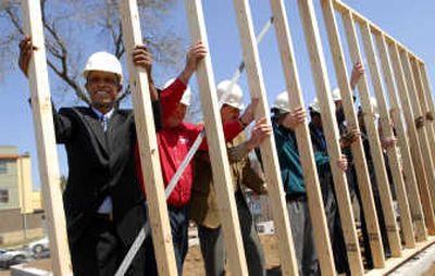 
Kuma Mulessa, left, joins Habitat for Humanity volunteers and community leaders in raising the framing for his future home last month in the Frogtown neighborhood of St. Paul, Minn. Associated Press
 (Associated Press / The Spokesman-Review)