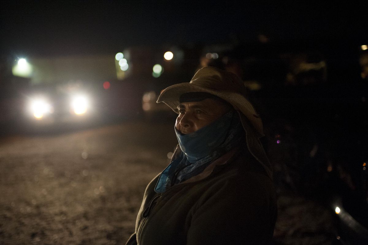 Isabel Vega waits for a van to take her and her daughter Irene Vega, to an Orchard north of Wenatchee -- near Chelan, Wash -- to work on Friday, July 15, 2016, in Wenatchee, Wash. (Tyler Tjomsland / The Spokesman-Review)