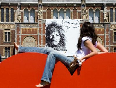 
A woman sits in front of a Rembrandt poster recently at the Rijksmuseum in Amsterdam, Netherlands. The Dutch celebrate the 400th anniversary of Rembrandt's birth on Friday. The yearlong festival 