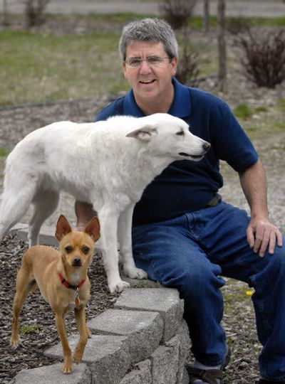 
Glenn Schultheis, owner of Dooty Free Dog Waste Removal Service, sits with his dogs  Cid, front, and Oggie. 
 (Dan Pelle / The Spokesman-Review)