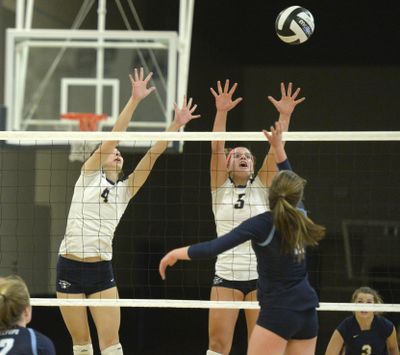 Maddie Lee (5) goes up to block Gonzaga Prep's Kate Budig during a Greater Spokane League volleyball match Oct. 13, 2015. (Jesse Tinsley / The Spokesman-Review)