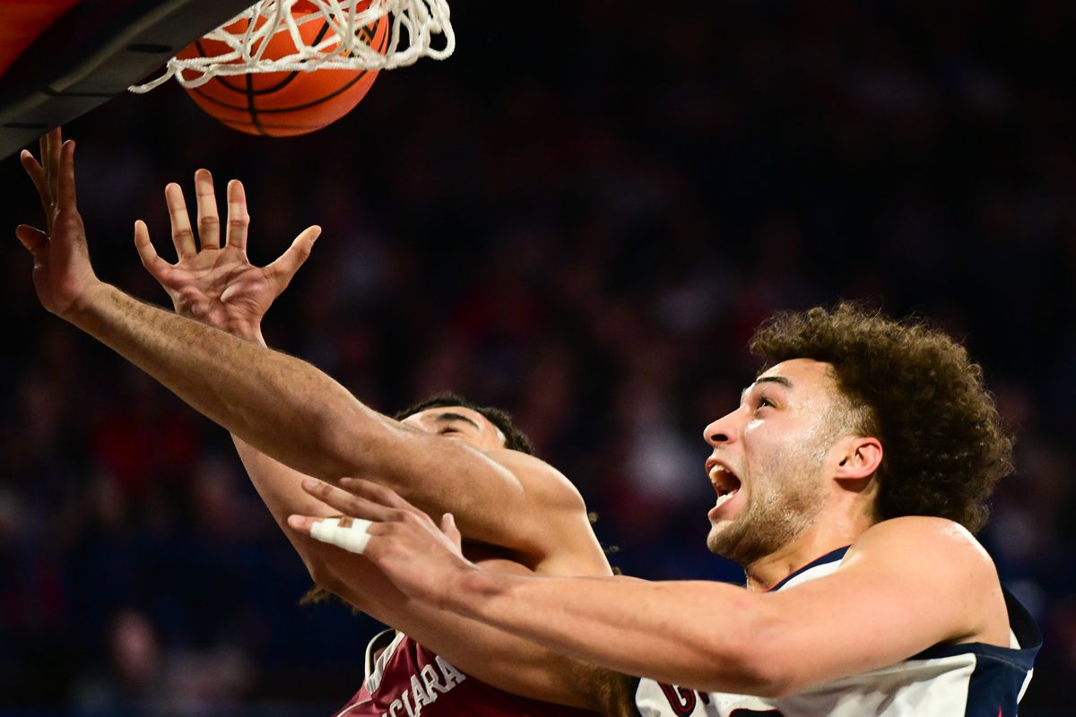 Gonzaga Bulldogs forward Anton Watson (22) battles Santa Clara Broncos forward Camaron Tongue (21) at the rim during the second half of a college basketball game on Thursday, Feb 2023, at McCarthey Athletic Center in Spokane, Wash. Gonzaga won the game 88-70.  (Tyler Tjomsland/The Spokesman-Review)