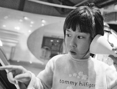 
Shania Siah looks at an exhibit during a tour of the Corning Museum of Glass in Corning, N.Y., in March. The number of Chinese who travel outside their homeland each year is expected to nearly triple to 100 million people by 2020, and American cities and businesses are hoping to profit from what could be a sizeable tourism boom. 
 (Associated Press photos / The Spokesman-Review)