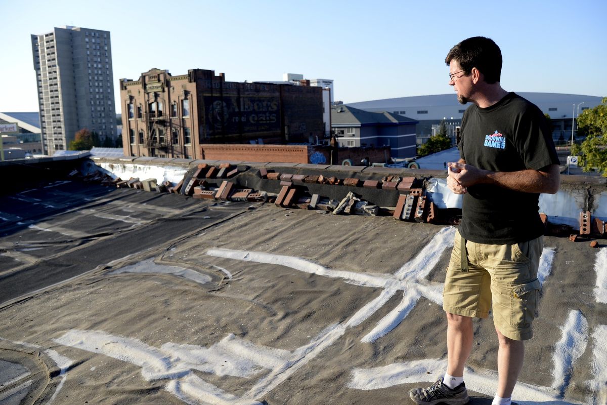 John Waite stands on the roof of his building Monday, Sept. 28, 2015 on Main Ave. near Division. He found a stranger running on his roof in the middle of the night and after the stranger was arrested, found out the intruder was a member of the military. (Jesse Tinsley)