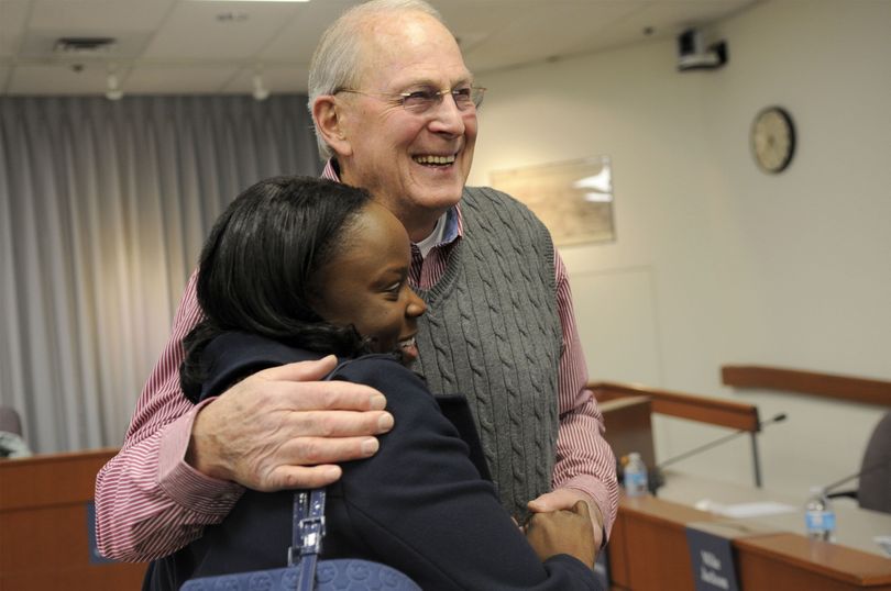 Spokane Valley City Councilman/Deputy Mayor Gary Schimmels is greeted by Latisha Hill, regional business manager for Avista, during a farewell gathering at Spokane Valley City Hall on Tuesday. (Kathy Plonka)