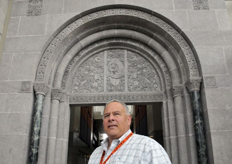 Wayne McKnight, the athletic director at West Valley High School, stands under the historic entryway that was salvaged from the old building and built into the new West Valley campus May 16. (Jesse Tinsley)