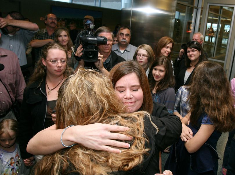 Laura Silsby, center, of Meridian, Idaho arrives at the Boise, Idaho airport on Tuesday, May 18, 2010. The missionary was released from a Haitian jail on Monday after being held for over three months accused of trying to take 33 children from Haiti after the deadly January earthquake. Silsby was freed Monday when a judge convicted her but sentenced her to time already served. (Joe Jaszewski / The Idaho Statesman)