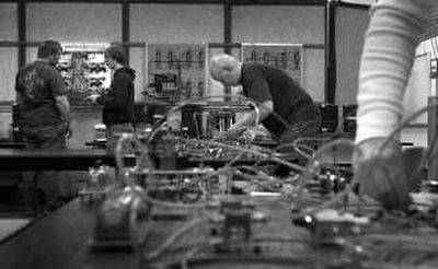 
SCC students work on a pneumatics test to create a circuit. Completion of the two-year program virtually guarantees a good-paying position. 
 (Brian Plonka / The Spokesman-Review)
