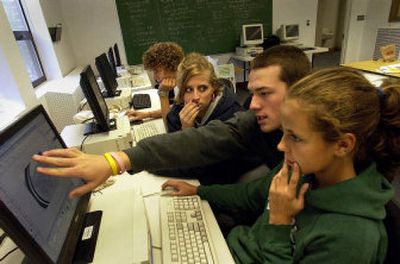 From left, Devin Merrill, 16, works on the logo for Rivercity Leadership Academy while Brittny  Hood, 15, Alex Pedersen, 17, and Bryanna Merrill, 13, work on the Web site in the computer room.
 (Liz Kishimoto / The Spokesman-Review)