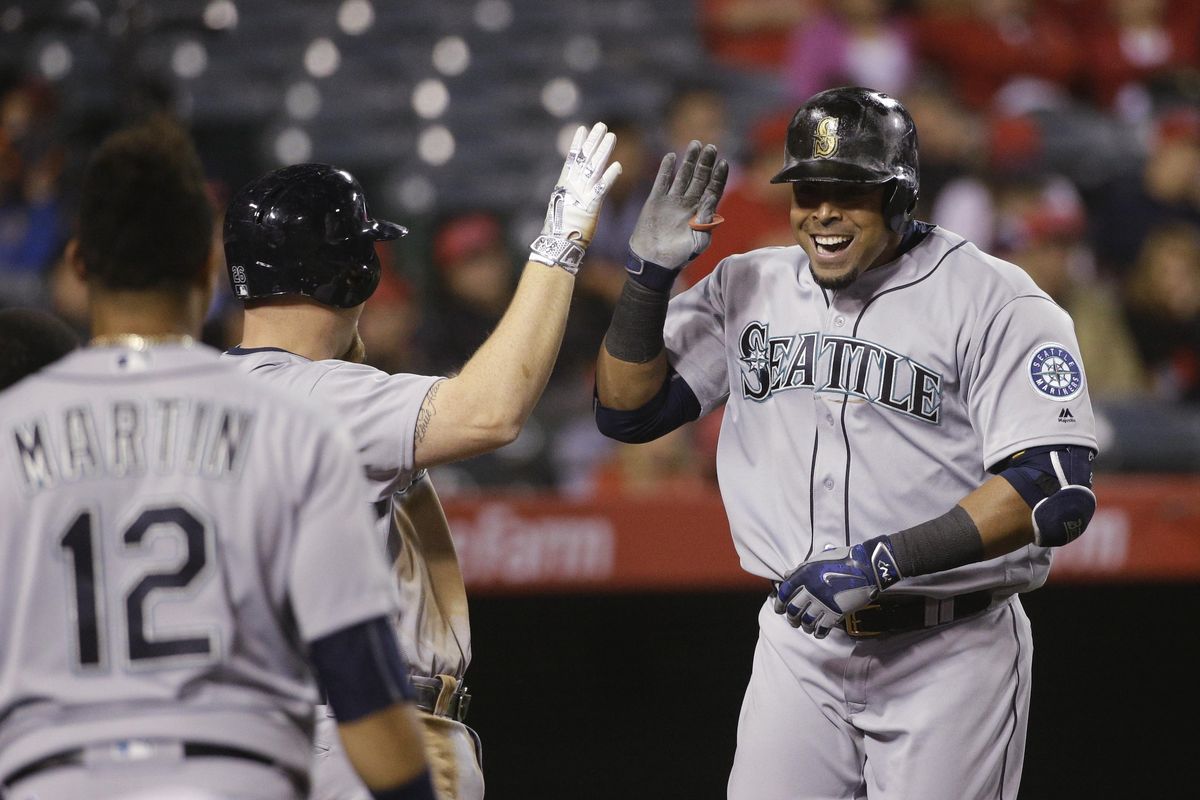 Mariners’ Nelson Cruz, right, celebrates his two-run home run with Adam Lind in 10th inning. (Jae C. Hong / Associated Press)
