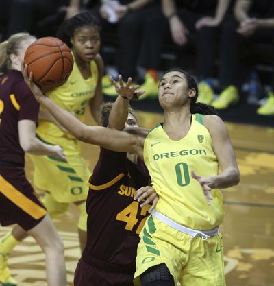 Oregon’s Satou Sabally, right, goes up for a shot ahead of Arizona State’s Courtney Ekmark, left, Oregon’s Oti Gildon and Arizona State’s Kianna Ibis during the fourth quarter of an NCAA college basketball game Friday, Jan. 18, 2019, in Eugene, Ore. (Chris Pietsch / Associated Press)