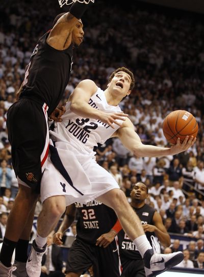 BYU’s Jimmer Fredette, right, scoops a shot over San Diego State’s Malcolm Thomas. (Associated Press)