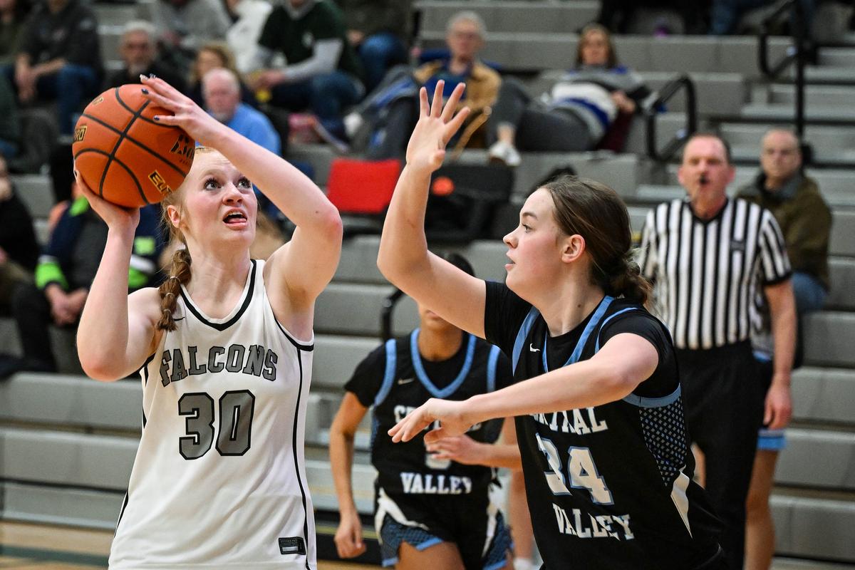 Ridgeline post Madilyn Crowley lines up a shot as Central Valley guard Olivia Patshkowski defends during a GSL high school basketball game on Friday at Ridgeline High School.  (Colin Mulvany/The Spokesman-Revi)