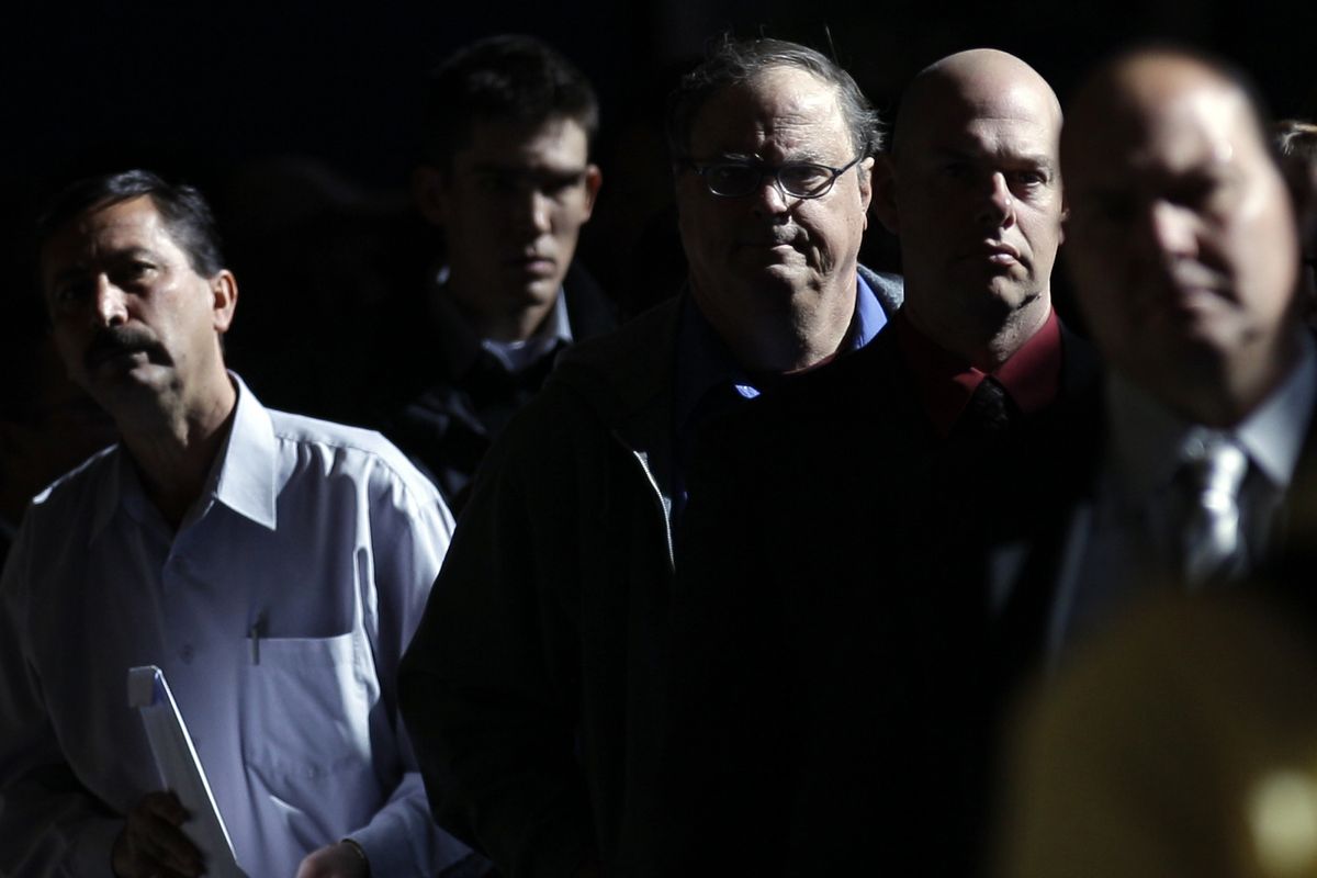 Mark Chavez, right, waits in a line to register at a career fair in San Diego on Nov 30. More Americans signed up for jobless benefits last week, but the trend in layoffs points to a healing jobs market.  (Associated Press)