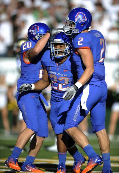 Boise State running back Doug Martin (22) is congratulated by teammates Mitch Burroughs (20) and Matt Miller (2) after scoring a touchdown against Colorado State during the first half. Martin ran for 200 yards on 20 carries, scoring three touchdowns. (Associated Press)