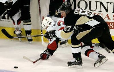Pittsburgh's Sidney Crosby, right, steals the puck from Ottawa Senators' Dean McAmmond in the first period.Associated Press
(Associated Press / The Spokesman-Review)