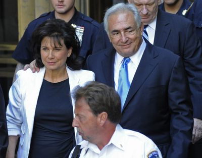 Former International Monetary Fund leader Dominique Strauss- Kahn leaves court in New York City with his wife, Anne Sinclair, on Friday. (Associated Press)
