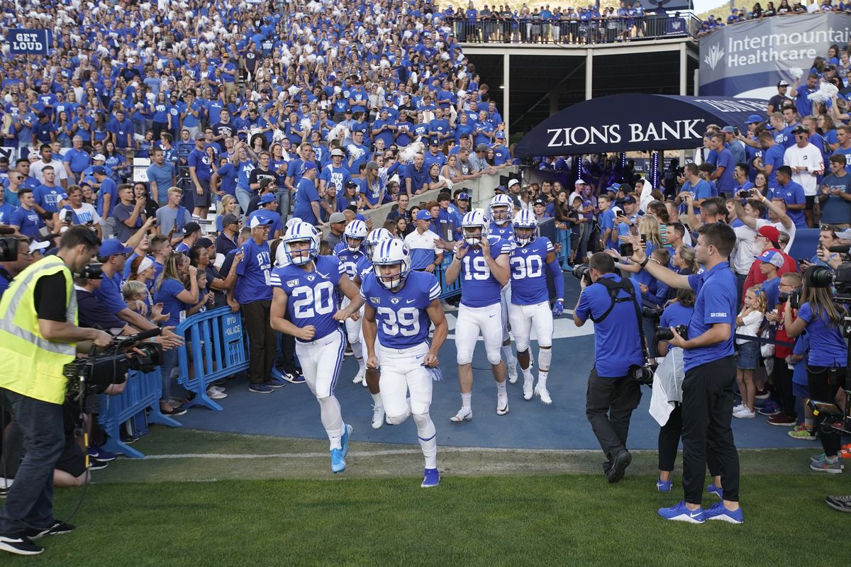 BYU football players enter the field to warm up for a game against Utah in Provo, Utah, in this Aug. 29, 2019, file photo. A deal BYU has made available to its football players could test how much allowing athletes to be compensated by outside companies for name, image and likeness can be used as a competitive advantage. On Thursday, BYU announced Built Brands – a Utah-based company that makes protein-heavy snacks – will give the opportunity for all 123 members of its football team to be paid to promote its products.  (Associated Press)