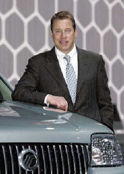 
Ford Motor Co., Chairman and CEO Bill Ford stands next to a Mercury Mariner hybrid vehicle on the floor of the North American International Auto Show in Detroit this month. 
 (Associated Press / The Spokesman-Review)