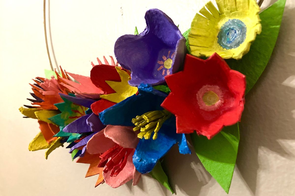 Create a colorful wreath by cutting an egg carton into flower shapes and painting the pieces.  (Katie Patterson Larson/For The Spokesman-Review)