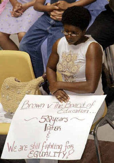 
Imani Sankofa, of Indianapolis, listens to a program commemorating the 50th anniversary of Brown vs. Topeka Board of Education at the Statehouse in Indianapolis on Monday.Imani Sankofa, of Indianapolis, listens to a program commemorating the 50th anniversary of Brown vs. Topeka Board of Education at the Statehouse in Indianapolis on Monday.
 (Associated PressAssociated Press / The Spokesman-Review)