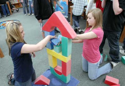 
Seventh graders Kyanne Thrash and Ashley Eby build their version of The Leaning Tower of Pisa with building blocks in the Pacific Science Center's Engineering van last month. 
 (J. BART RAYNIAK / The Spokesman-Review)