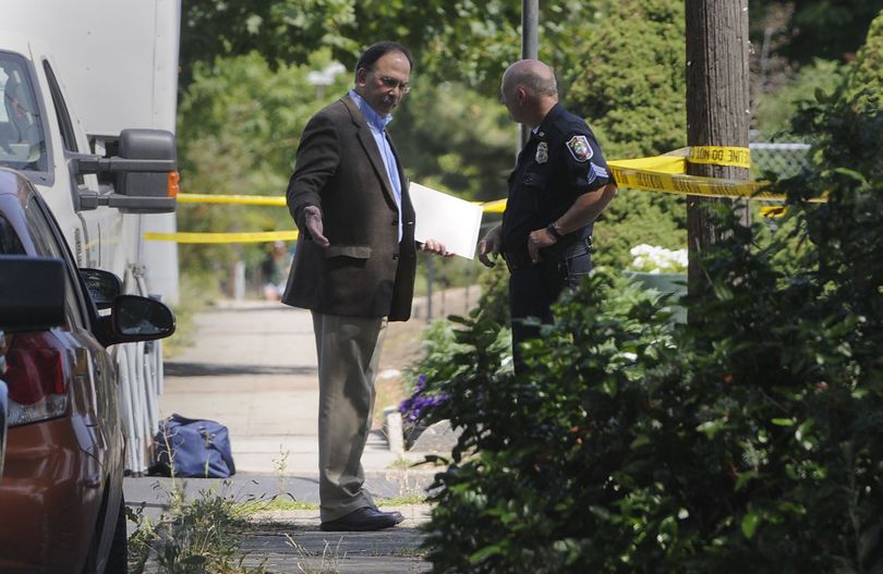 Assistant city attorney Rocky Treppiedi, left, arrives on the scene of an officer-involved shooting Friday, July 10, 2009, in Spokane. JESSE TINSLEY jesset@spokesman.com (Jesse Tinsley / The Spokesman-Review)