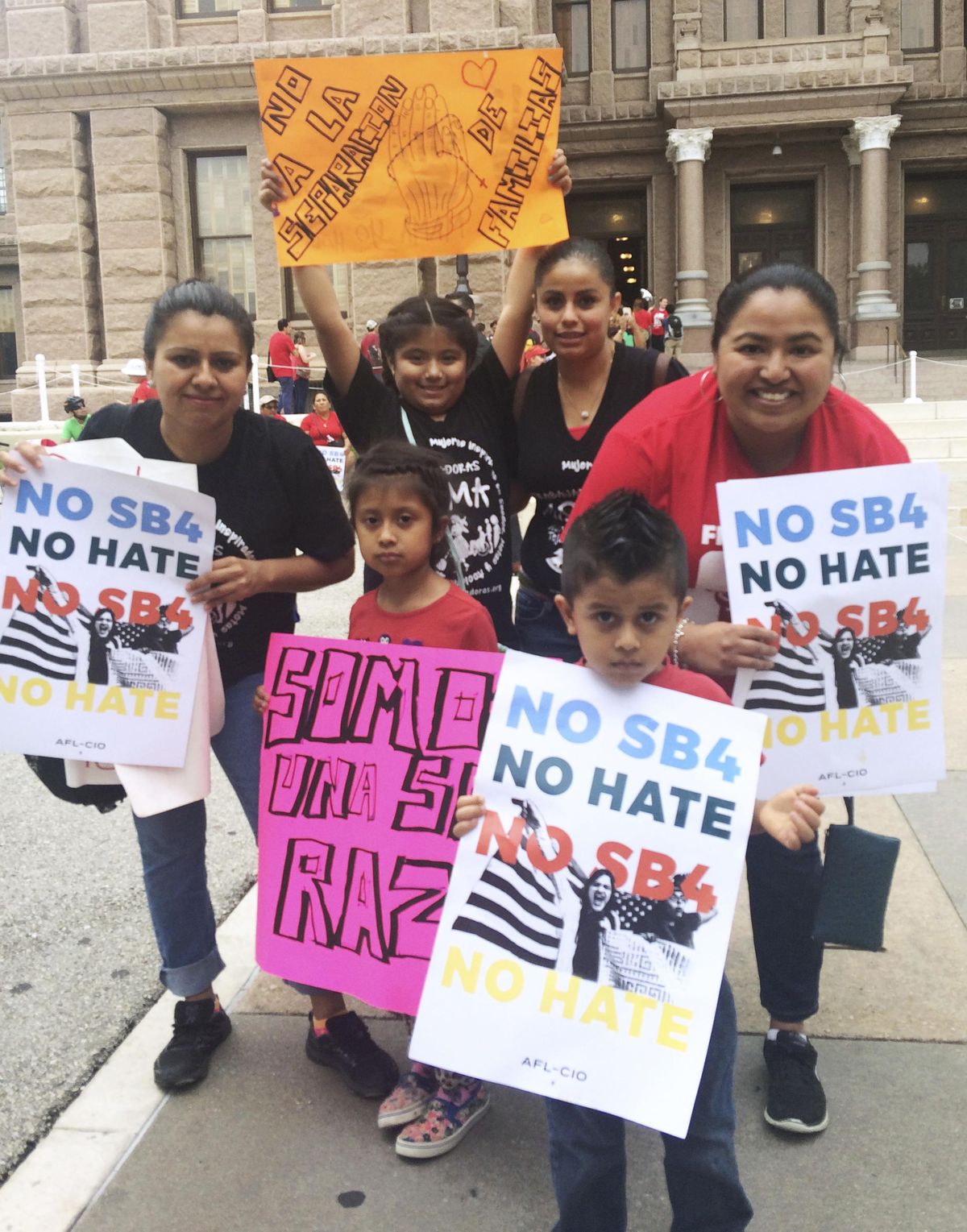 Rosario, right, and Marichuy, second from right in the back, demonstrate with family against a new Texas immigration law on Monday, May 29, 2017, in Austin, Texas. Opponents call Texas’ anti-sanctuary cities law a “show your papers” law since it empowers police to inquire about peoples’ immigration status during routine interactions such as traffic stops. (Meredith Hoffman / Associated Press)