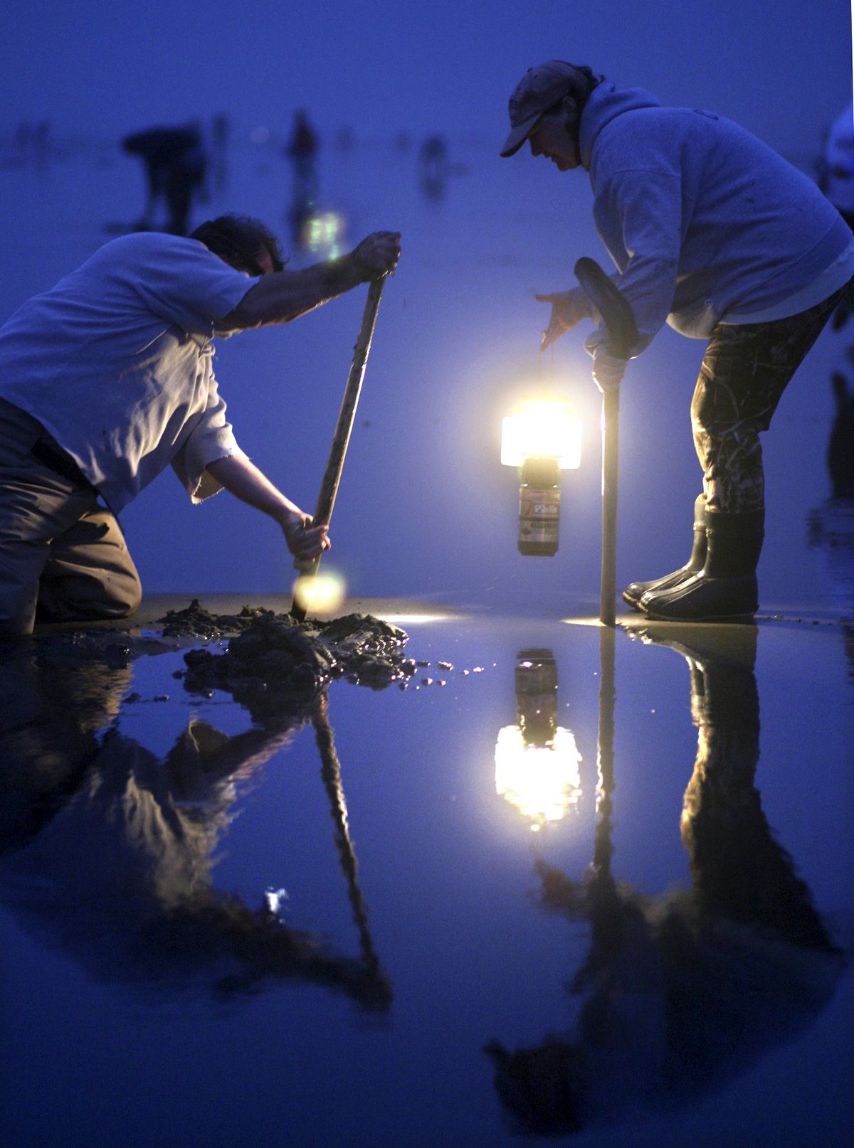 Razor clam digging is linked to the low tides. In fall, that often means going out after dark by lantern light.Associated Press file (Associated Press file / The Spokesman-Review)