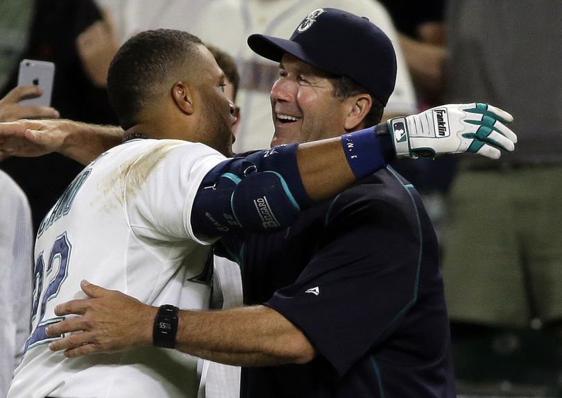 Edgar Martinez, right, has brought experience - and a great attitude – to the Mariners since becoming the hitting coach on June 20. (Associated Press)