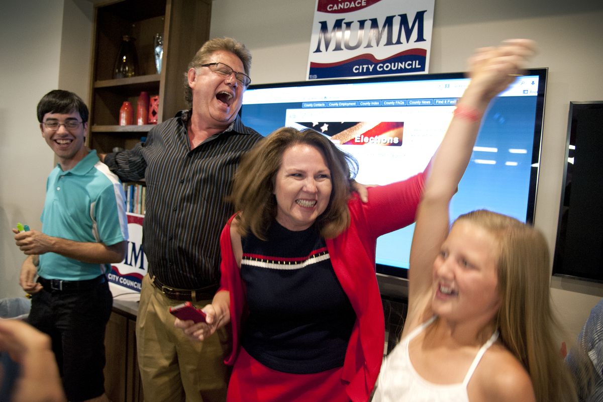 Spokane City Council District 3 candidate, Candace Mumm explodes with excitement as she celebrates winning 56% of the votes with, from left, campaign manager Nick Castrolang, husband Steve Mumm, and niece Morgan Armstrong, Aug, 6, 2013, at the Central Food building in Spokane