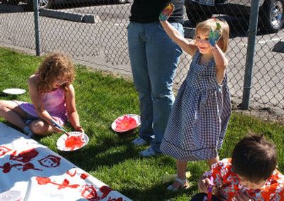 
 Mackenzie Allen, 3, shows off her paint-covered hands during the Spokane Valley Parks and Recreation drop-in program at Valley Mission Park on  Tuesday. The free program is available at Valley Mission Park from 9 a.m. to noon, at Edgecliff Park from 1  to 4 p.m. and at Browns Park from 1  to 4 p.m. 
 (Liz Kishimoto / The Spokesman-Review)