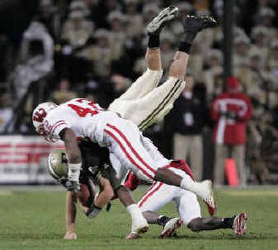 
Wisconsin's Robert Brooks, front, and Scott Starks force Kyle Orton's crucial fumble. 
 (Associated Press / The Spokesman-Review)