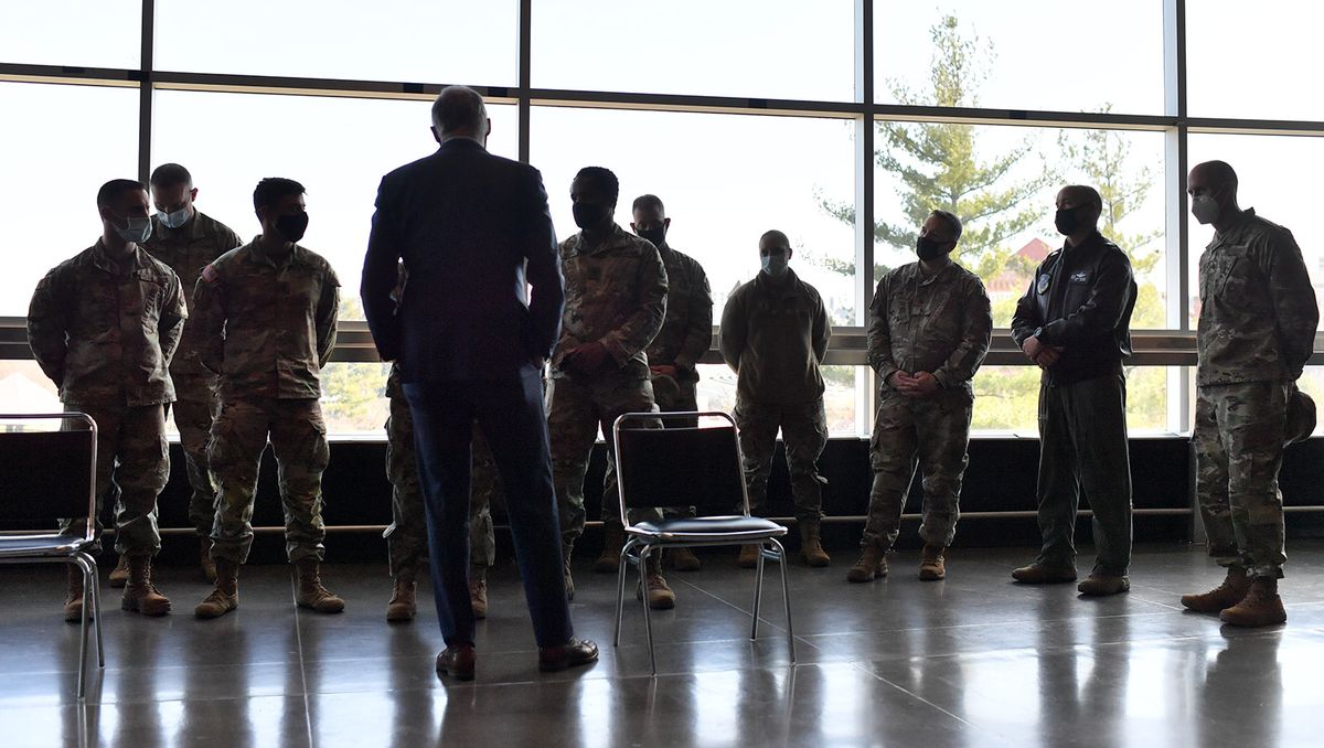 Washington Gov. Jay Inslee speaks with members of the Washington Air National Guard and Washington National Guard as he tours a mass Covid-19 vaccination site at Spokane Arena on Friday, April 9, 2021, at the Spokane Arena in Spokane, Wash.  (Tyler Tjomsland/The Spokesman-Review)